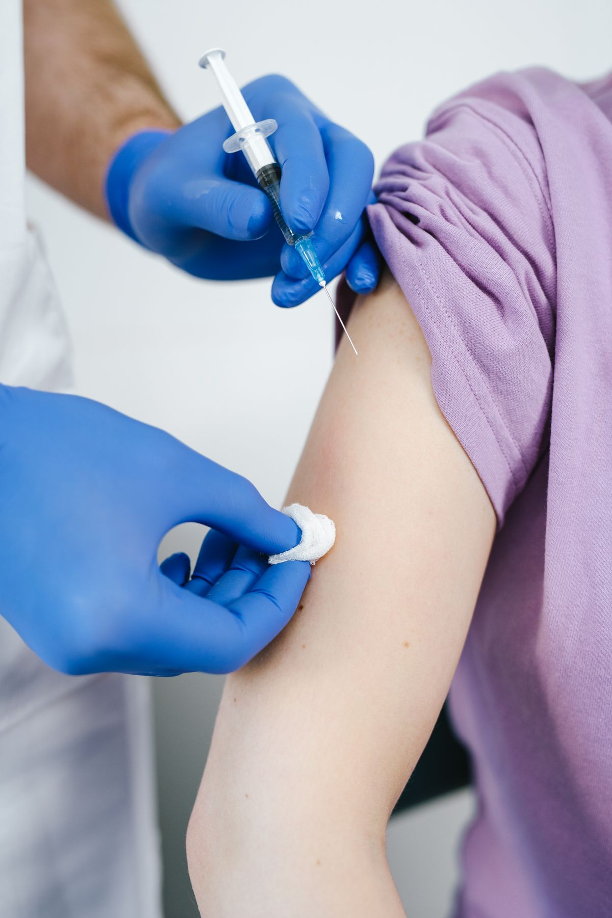 Primer plano de la administración de una vacuna en el brazo de un paciente