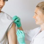 Healthcare professional administering a vaccine in a patient's arm
